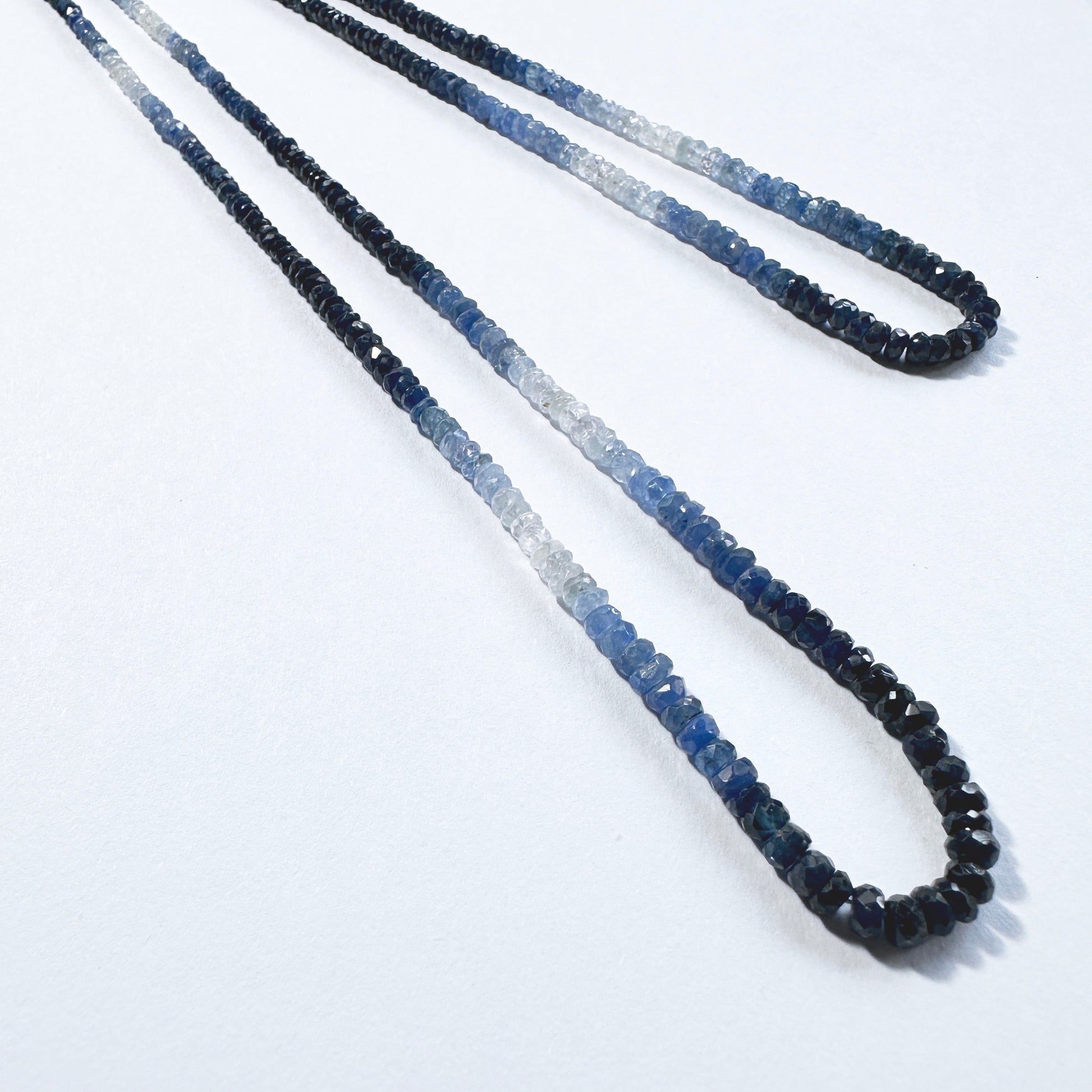 Shaded blue sapphire rondelle beads  sparkle across a 40cm strand with rich tonal variation.