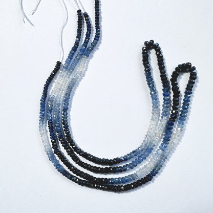 Faceted blue sapphire beads in rondelle cut show deep navy to light blue hues with exceptional clarity and shine.