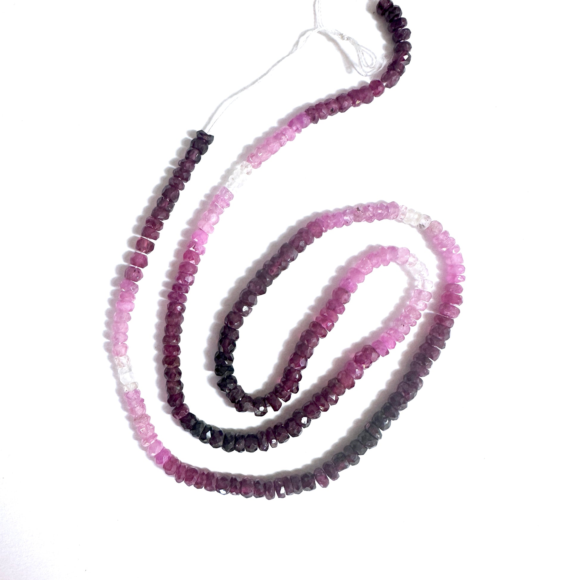  3.4mm Ruby beads showing vivid green tones and polished faceted surfaces.
