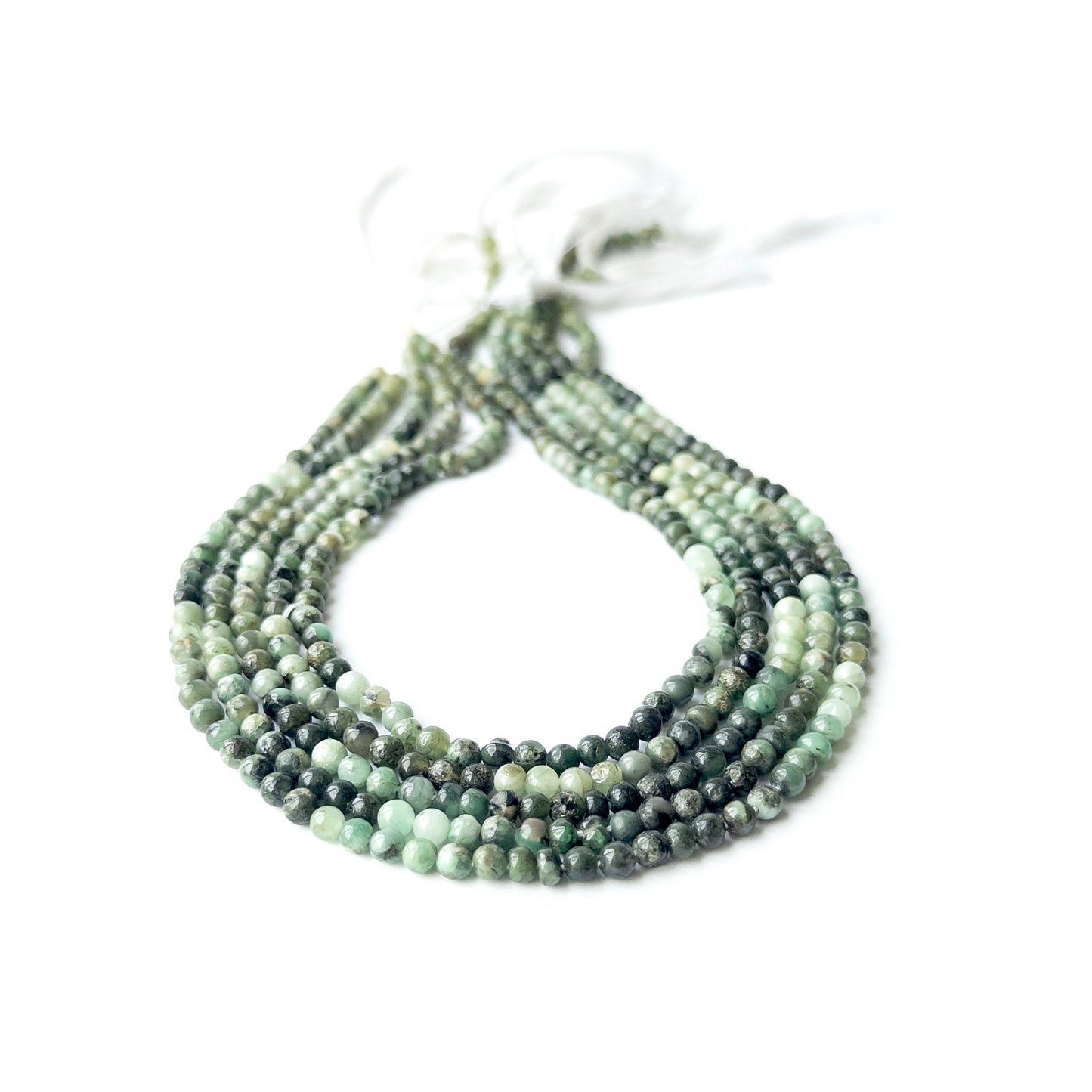 Shaded Emerald smooth round beads in 4–4.2mm, showing deep to light green tones for handmade jewellery components.