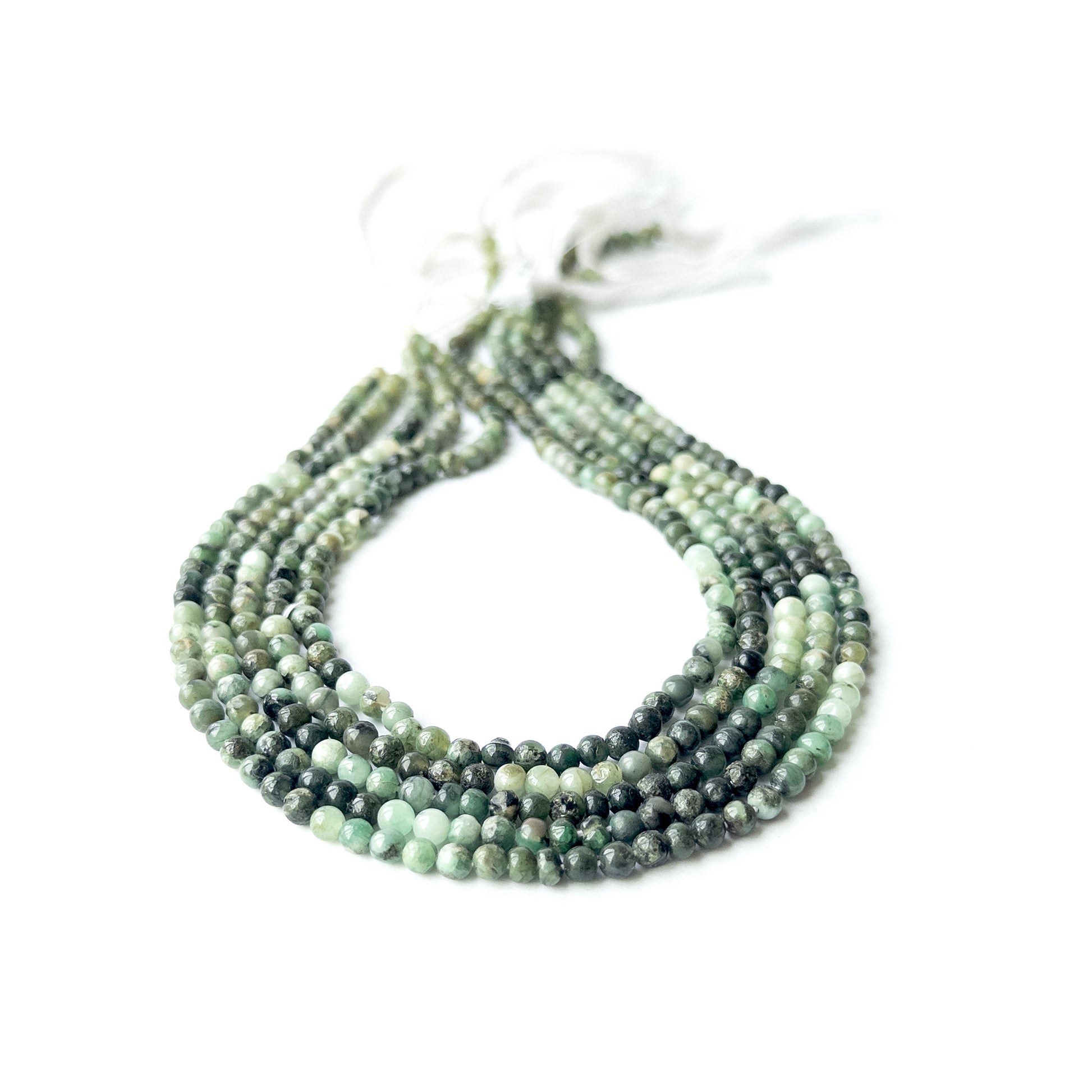 Shaded Emerald smooth round beads in 4–4.2mm, showing deep to light green tones for handmade jewellery components.