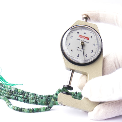 A dial gauge measures the Shaded Emerald smooth wheel Heishi 4–4.2mm gemstone.