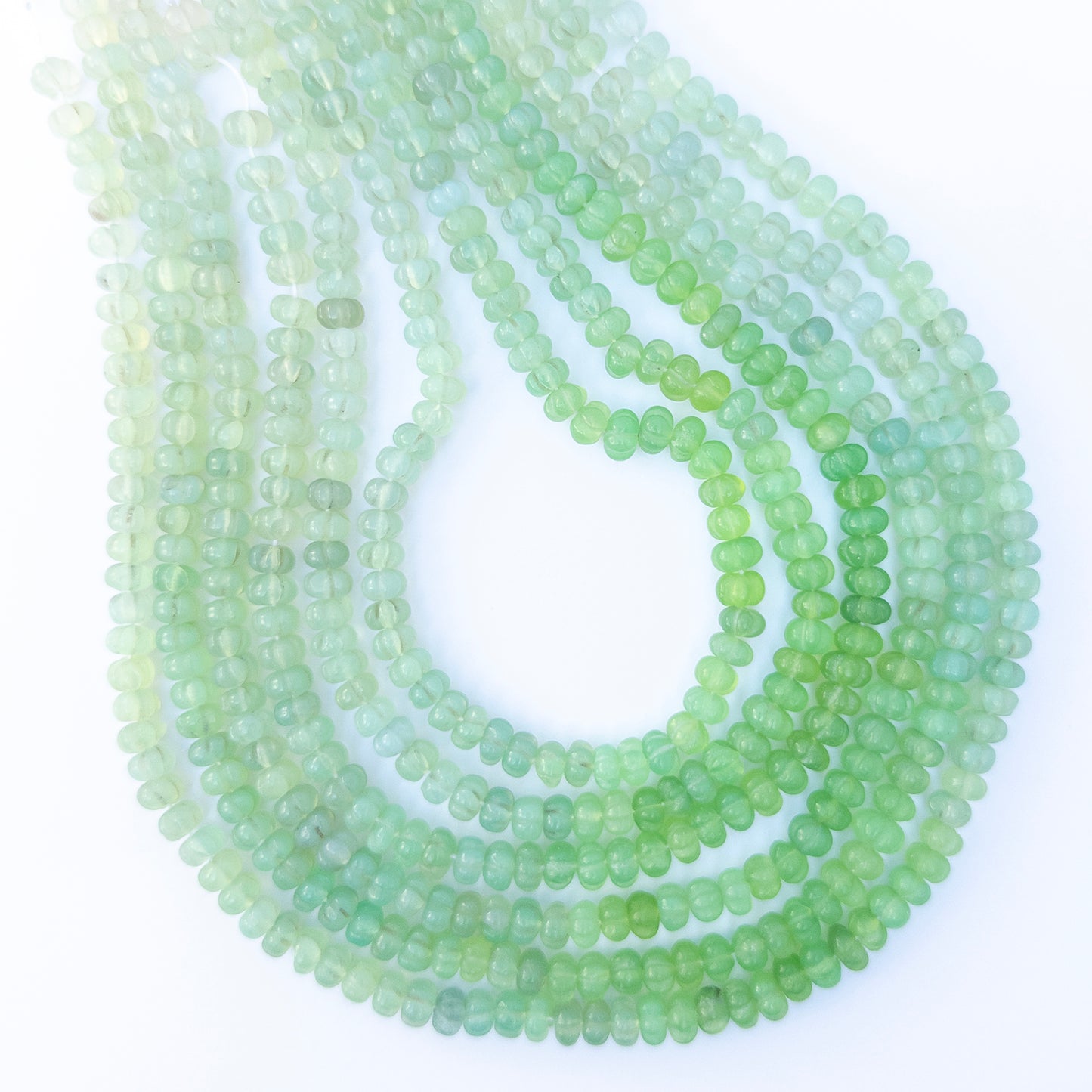 Shaded Green Chalcedony pumpkin cut gemstone beads arranged in a 40cm strand with soft green tones and polished shine.