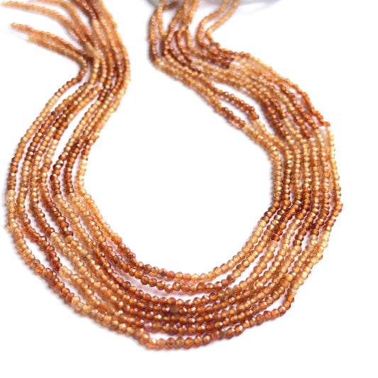 Faceted shaded hessonite beads displayed with shimmering surfaces ideal for natural gemstone jewellery making.