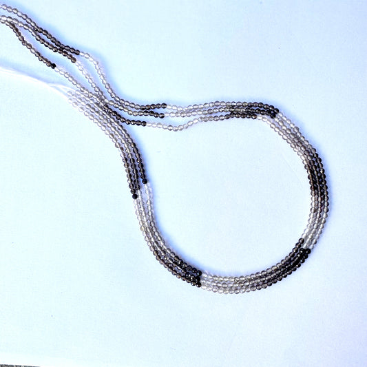 Shaded smoky quartz rondelle beads with 2.2mm size and faceted finish on a 32cm strand.