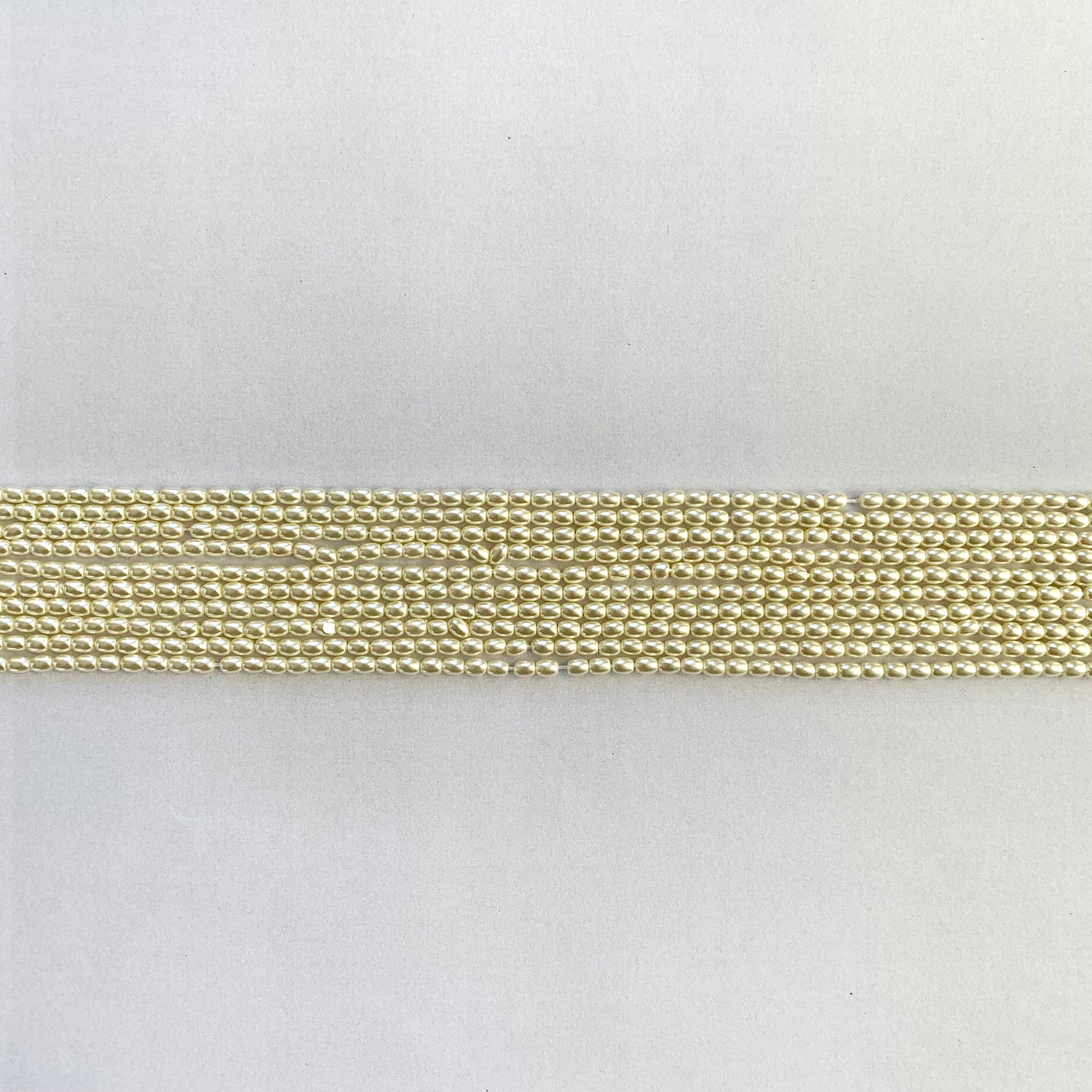 Beautifully arranged pearl strand featuring rice-shaped, white shell beads with gentle shine