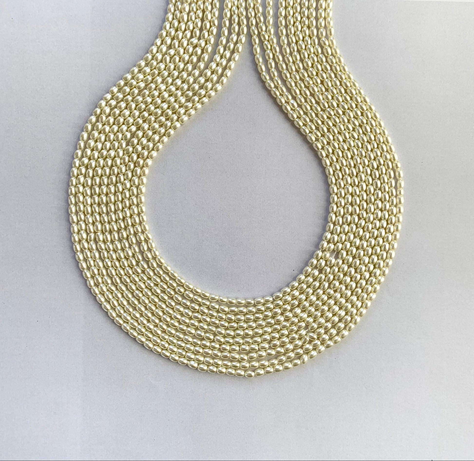 A strand of glossy white rice-shaped shell pearls arranged in a neat 41cm line.