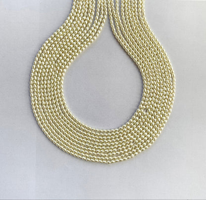 A strand of glossy white rice-shaped shell pearls arranged in a neat 41cm line.