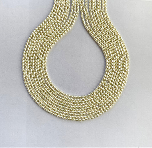 A strand of glossy white rice-shaped shell pearls arranged in a neat 41cm line.