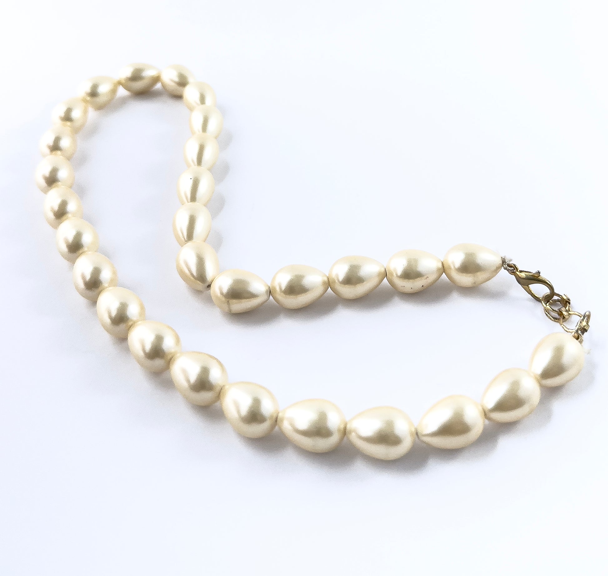 Smooth oval Shell Pearl beads in a 39cm necklace layout, perfect for creating timeless, elegant handmade jewellery components.