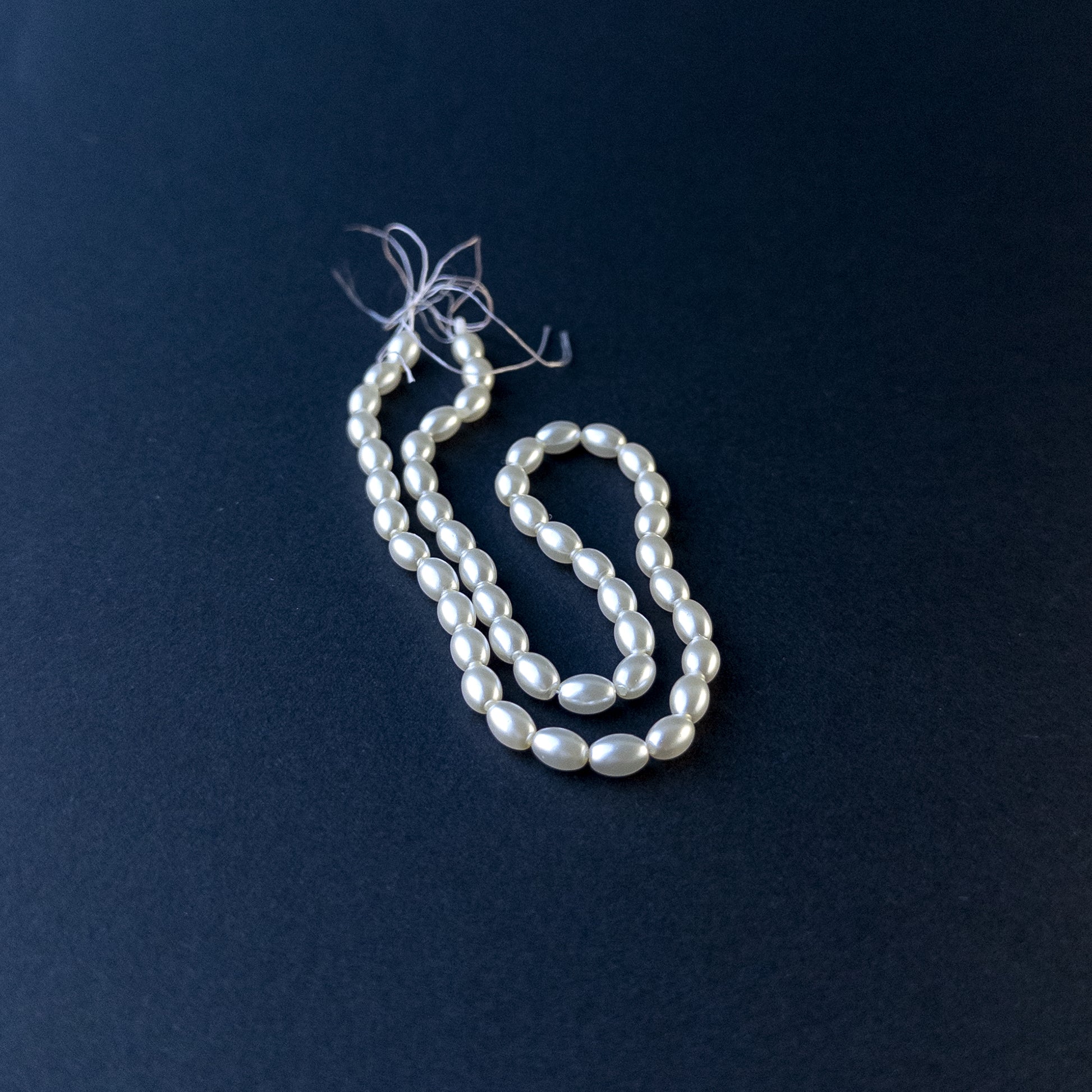 Shell Pearl smooth oval beads arranged on a 31cm strand for handmade jewellery components.