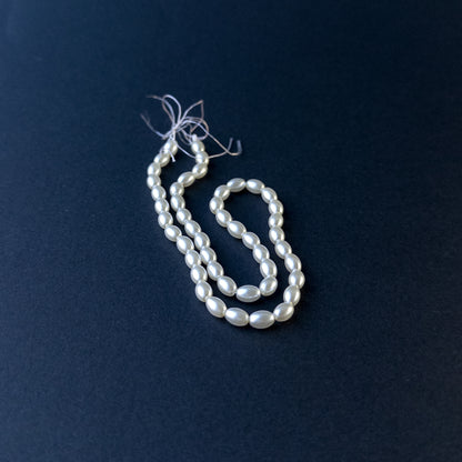 Shell Pearl smooth oval beads arranged on a 31cm strand for handmade jewellery components.