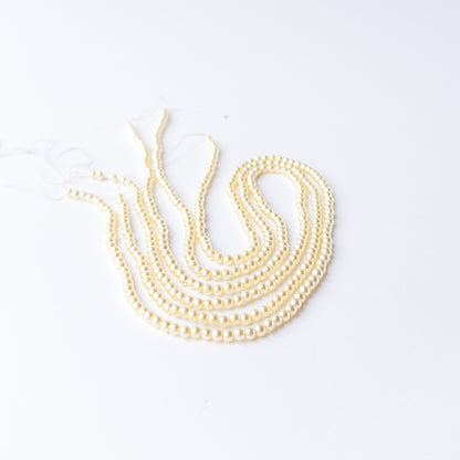 Genuine Shell Pearl gemstone beads showcasing polished finish and uniform round shape.