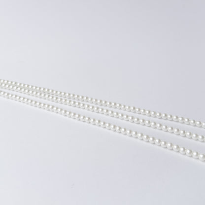 Shell Pearl gemstone beads arranged in a long strand for DIY jewellery and creative designs.