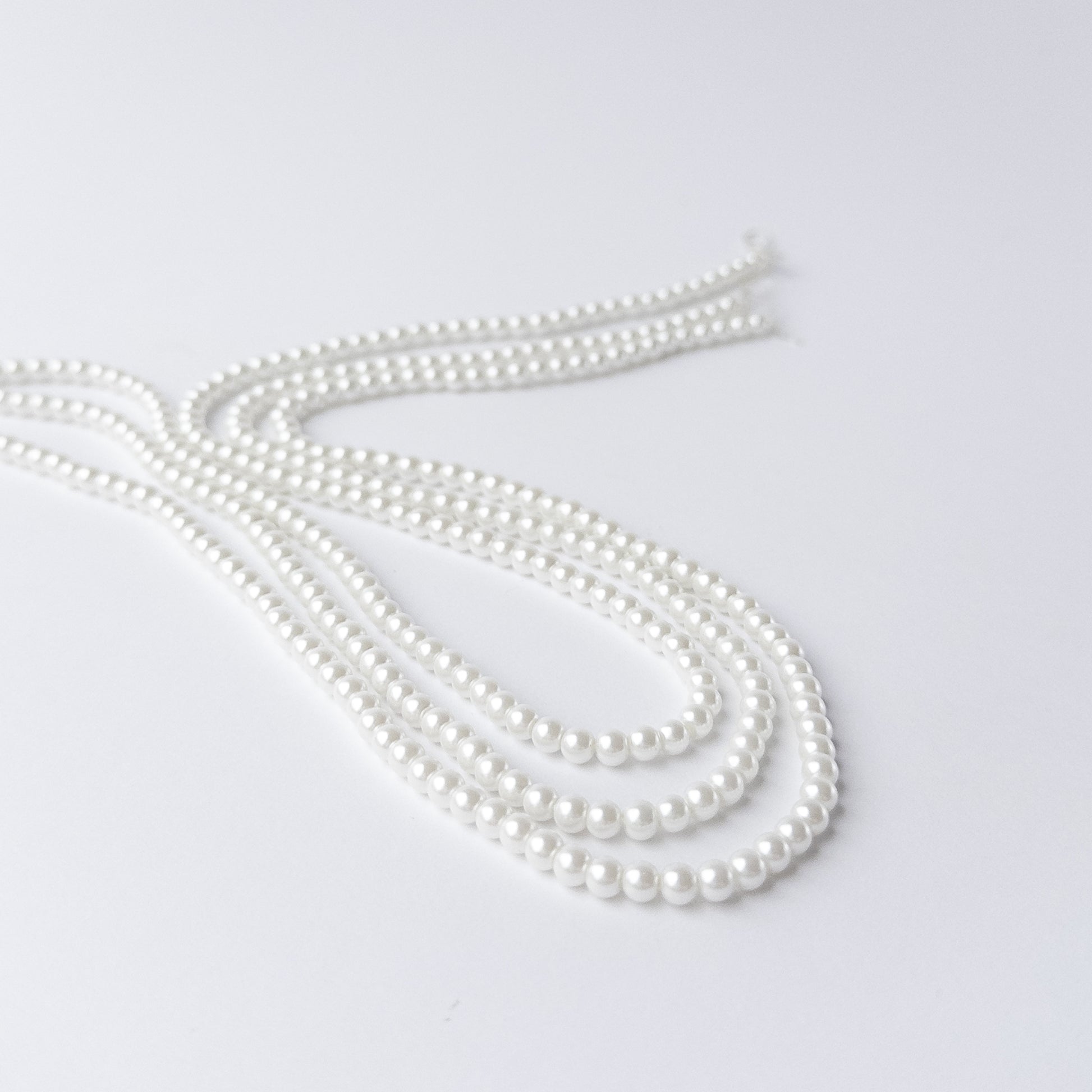 High-quality Shell Pearl beads arranged neatly for artisan jewellery and beadwork projects.