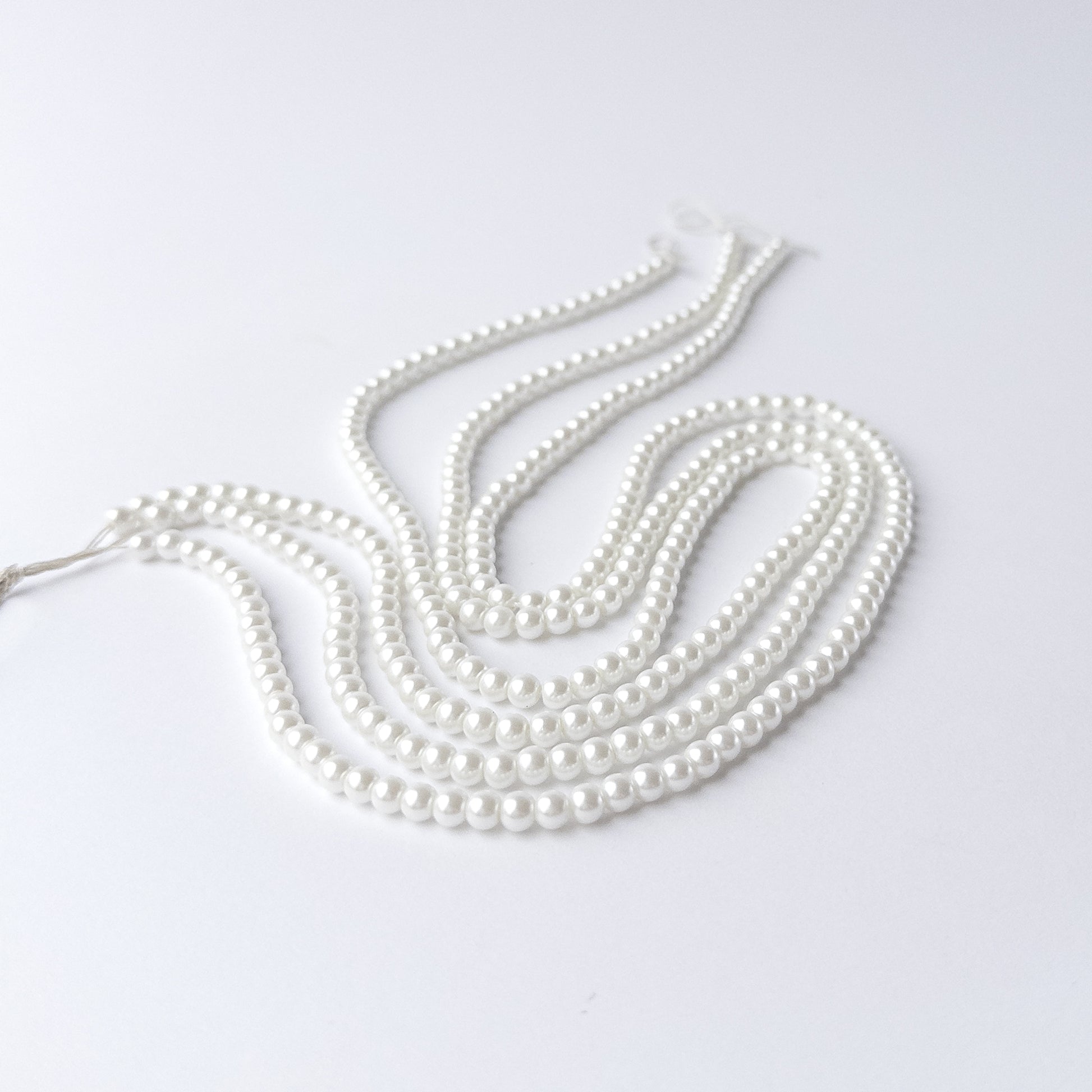 Close-up of Shell Pearl beads highlighting their polished surface and consistent shape.