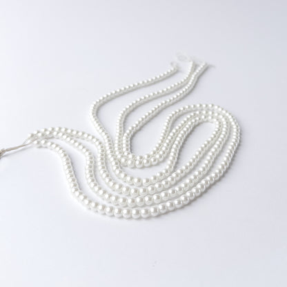 Close-up of Shell Pearl beads highlighting their polished surface and consistent shape.