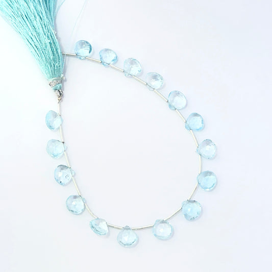 Sky Blue Topaz faceted briolette beads showing bright blue sparkle and polished gemstone cuts.