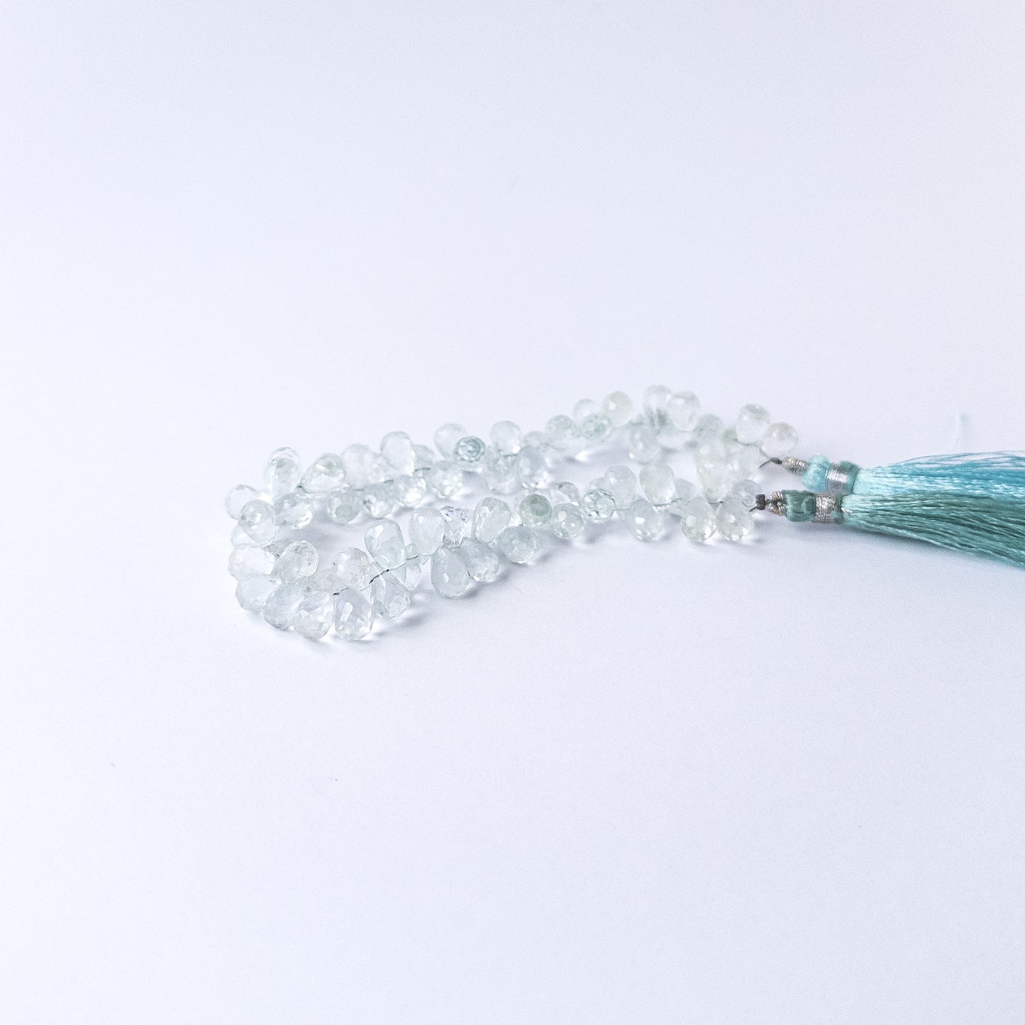 Authentic Topaz stone beads in teardrop briolette shape showcasing bright blue colour and high‑quality shine.