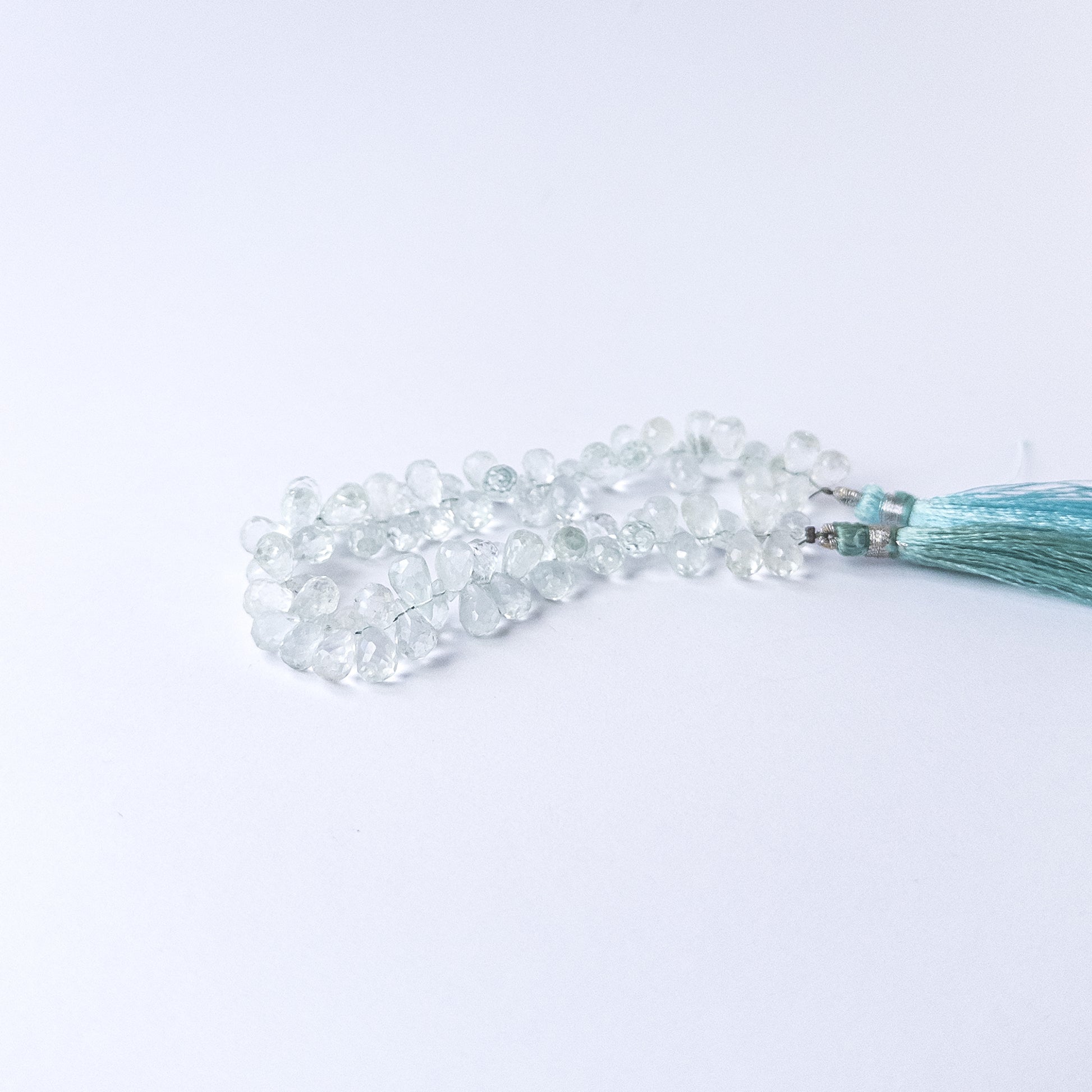 Authentic Topaz stone beads in teardrop briolette shape showcasing bright blue colour and high‑quality shine.