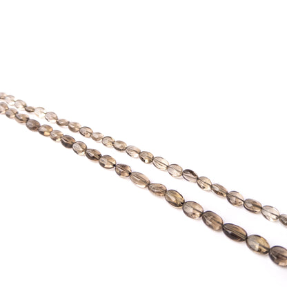 Genuine Smoky Quartz gemstone beads arranged on a 23cm strand with varied sizes and refined faceted finishes.