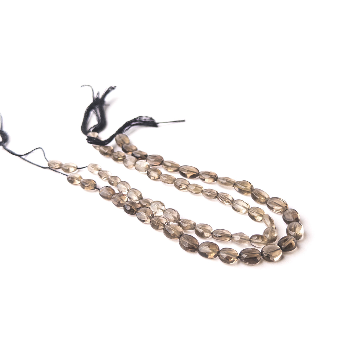 Smoky Quartz faceted oval gemstone beads displaying warm smoky brown tones with brilliant sparkle and elegant natural translucency.