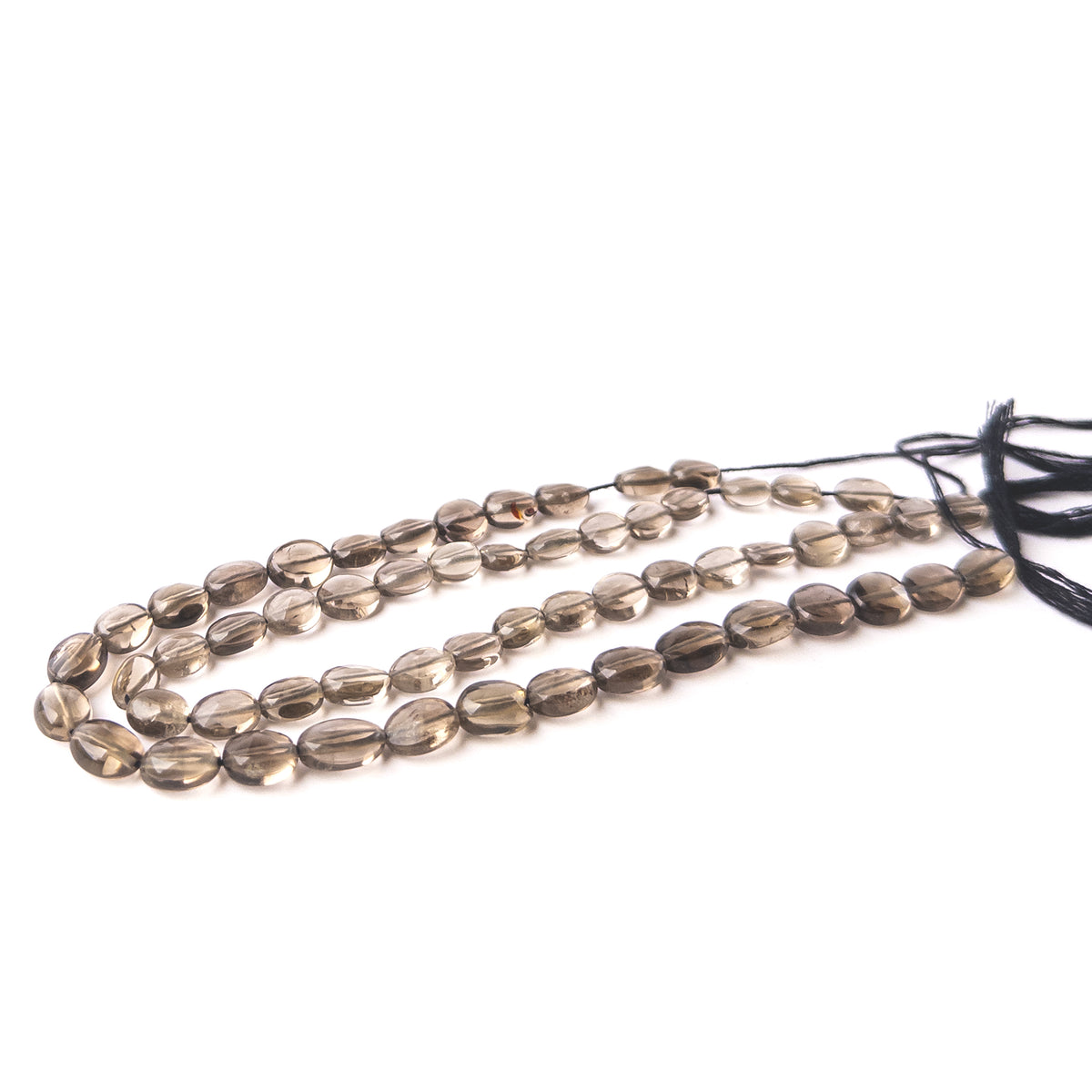 Authentic Smoky Quartz stone beads featuring faceted oval cuts that enhance light reflection and gemstone beauty.
