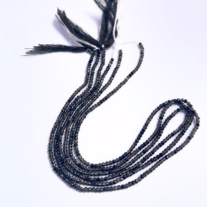 Close-up of Smoky Quartz gemstone beads showing faceted rondelle cut and sparkle.