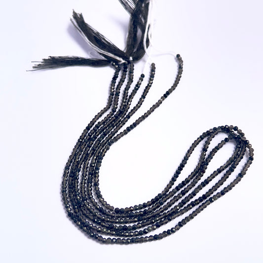 Close-up of Smoky Quartz gemstone beads showing faceted rondelle cut and sparkle.