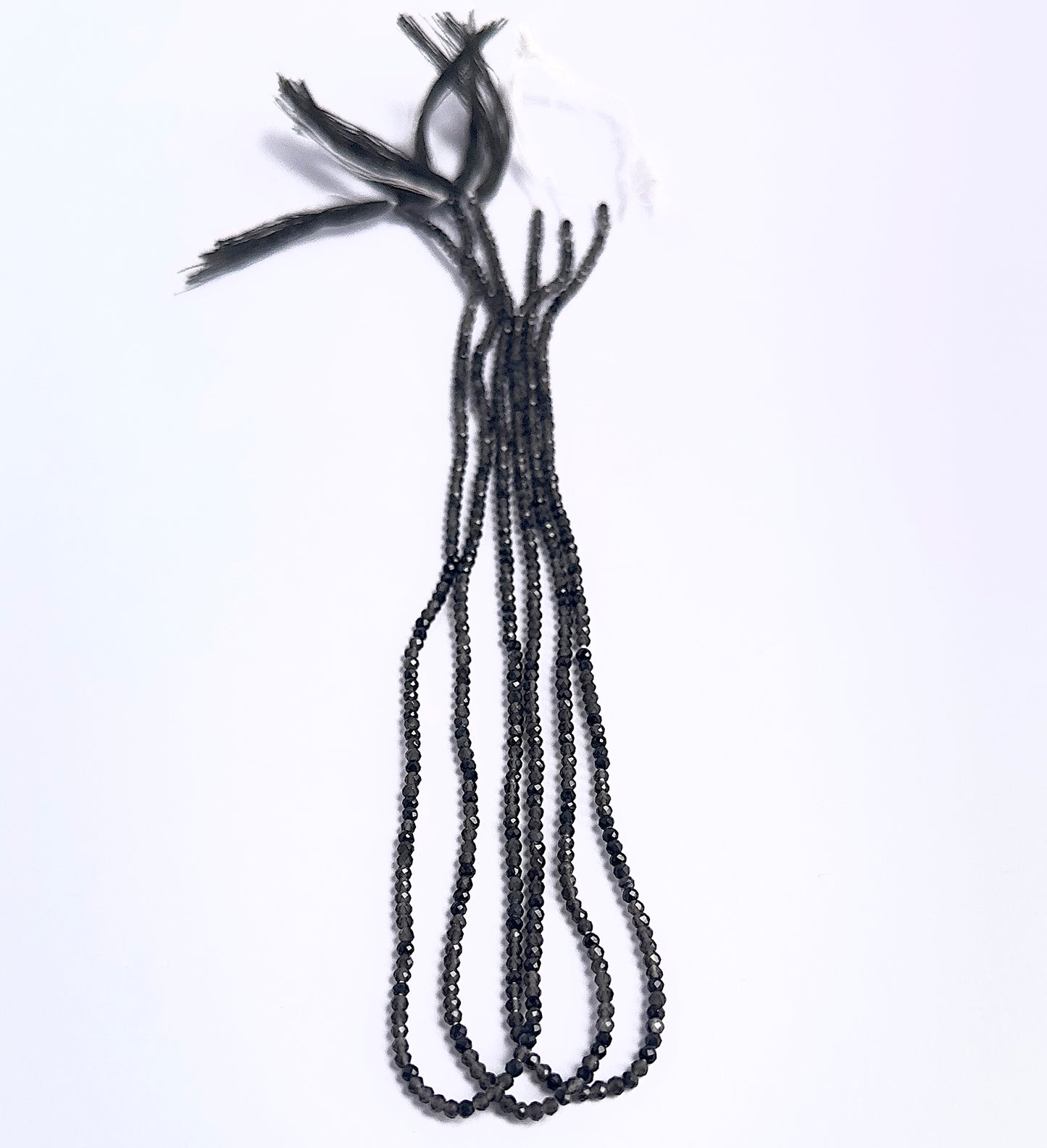 Natural Smoky Quartz stone beads arranged in strands with uniform size and shine.