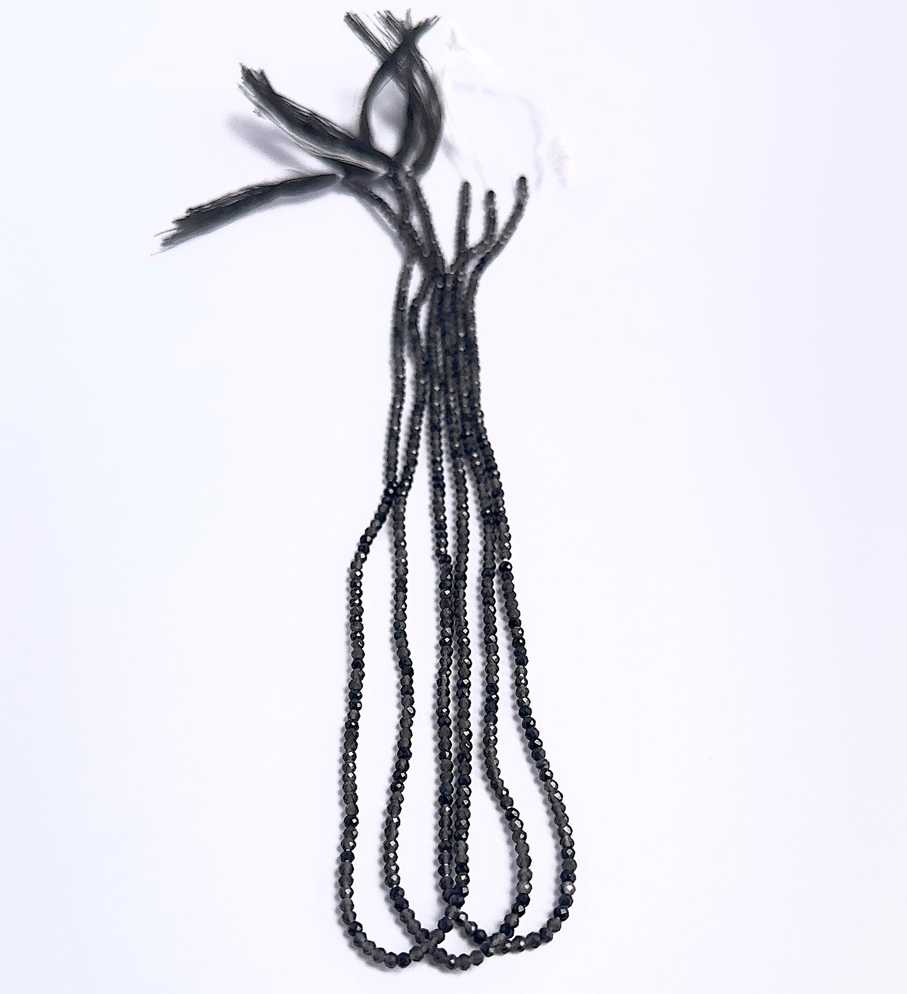 Natural Smoky Quartz stone beads arranged in strands with uniform size and shine.