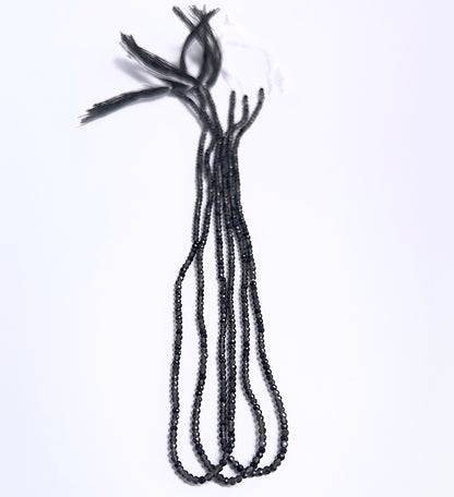 Natural Smoky Quartz stone beads arranged in strands with uniform size and shine.