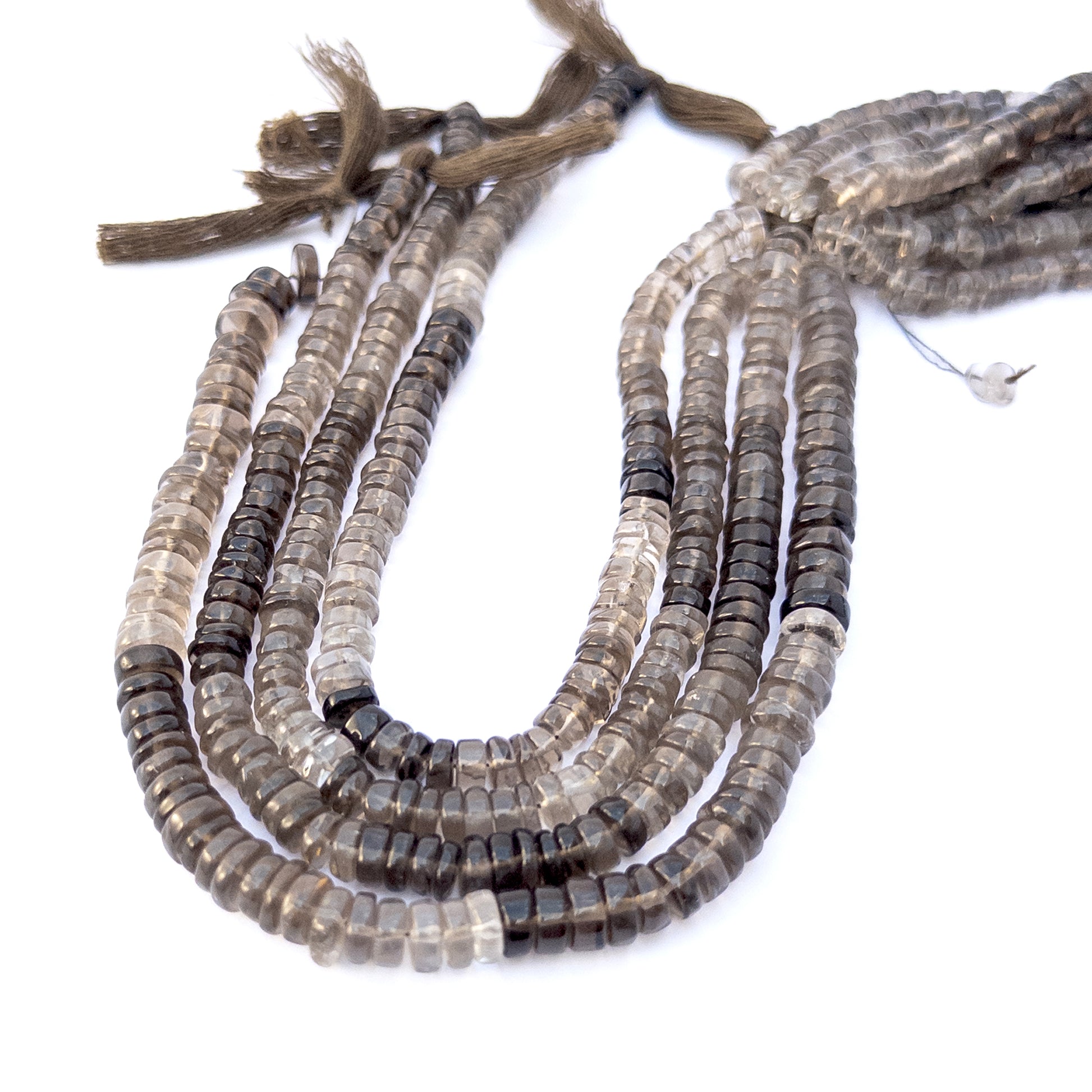 Smoky Quartz smooth rondelle gemstone beads arranged in a strand, showcasing warm earthy tones and polished shine.
