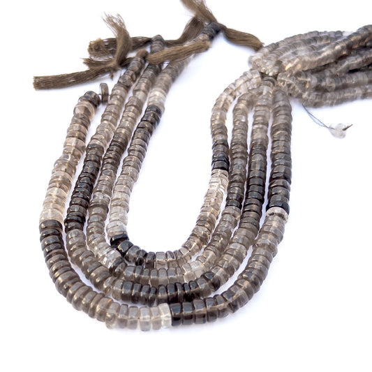 Smoky Quartz smooth rondelle gemstone beads arranged in a strand, showcasing warm earthy tones and polished shine.