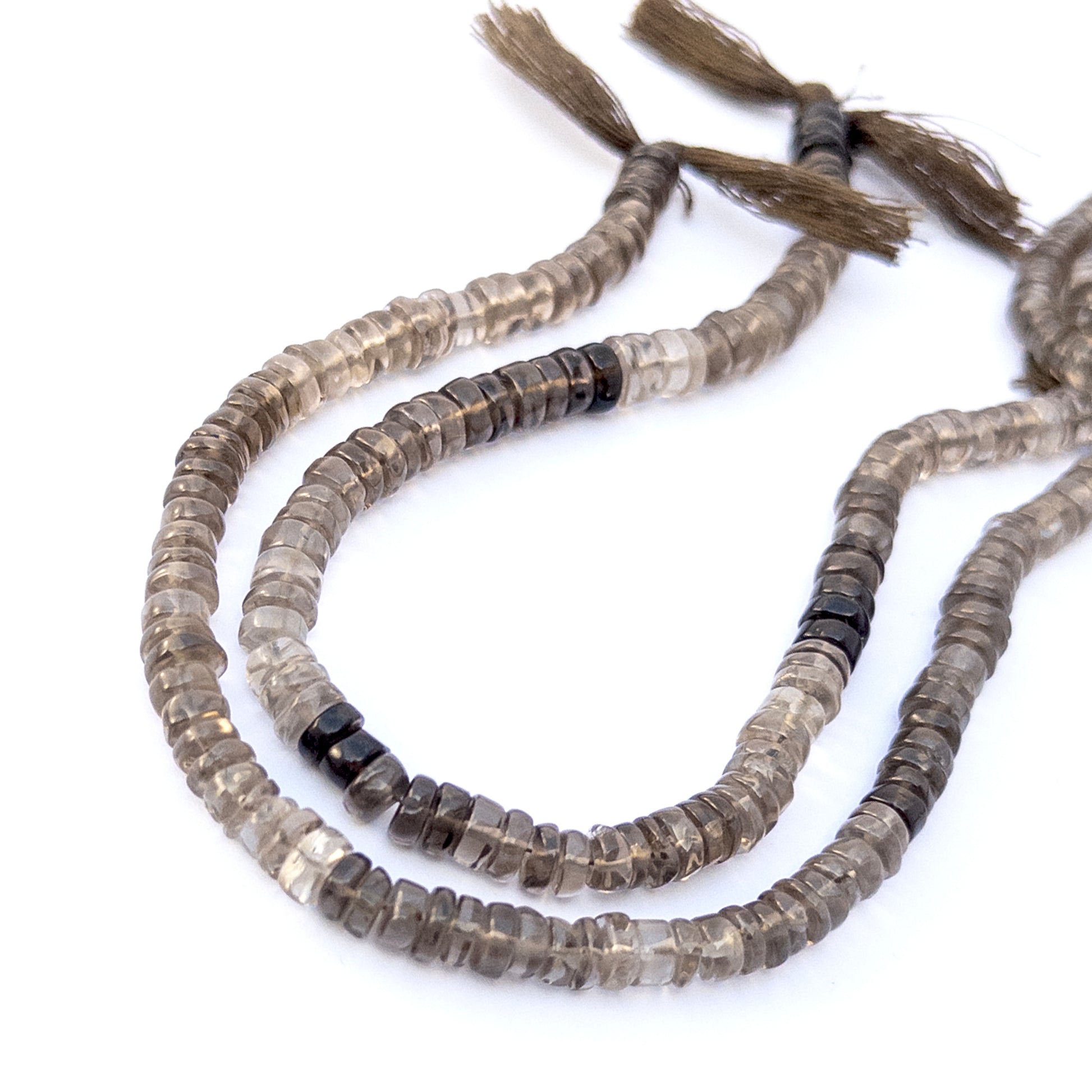 Close‑up of Smoky Quartz rondelle gemstone beads highlighting their glossy finish and gradient smoky colour.