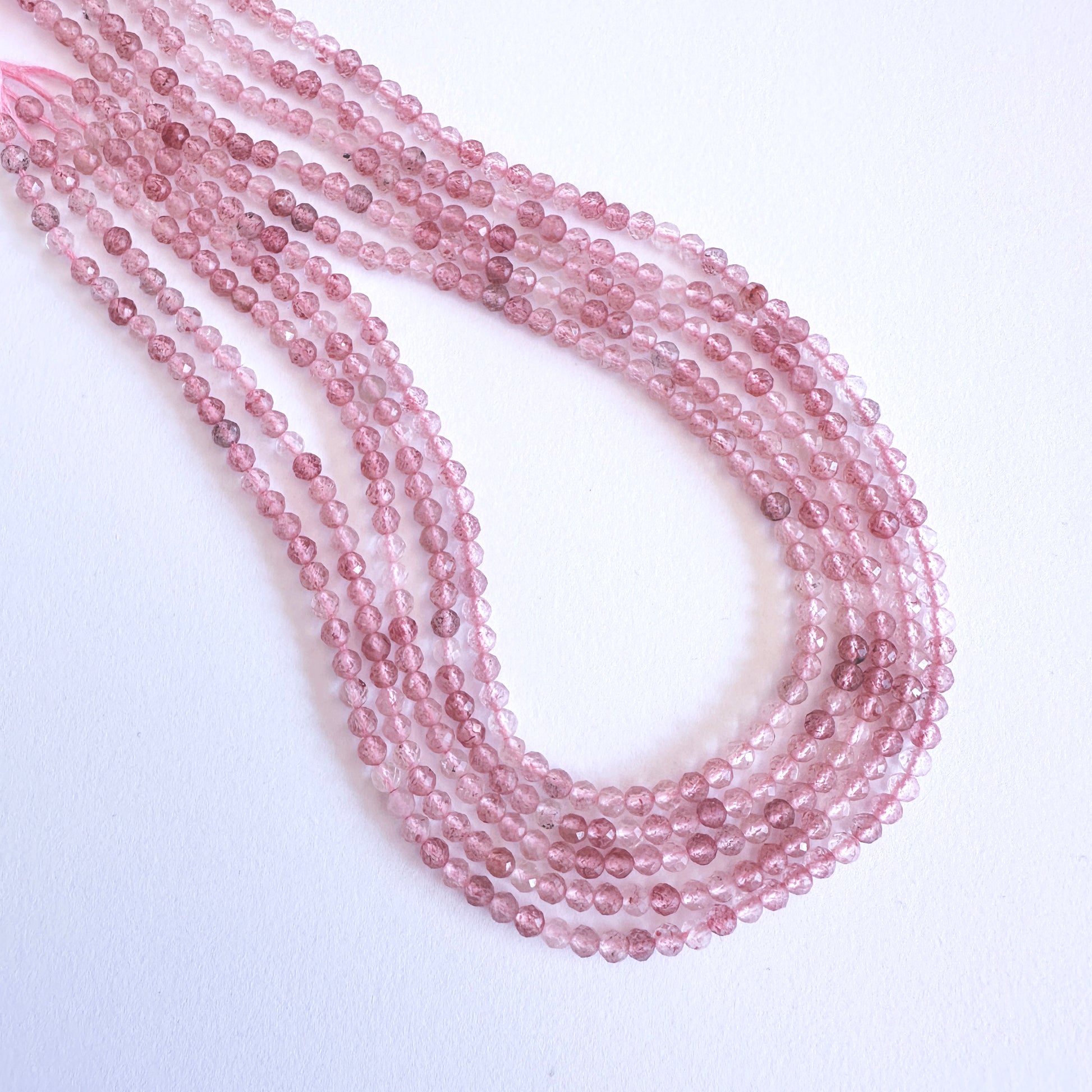 Handmade jewellery components with Strawberry Quartz beads arranged in a 31cm strand, ideal for romantic and elegant designs.