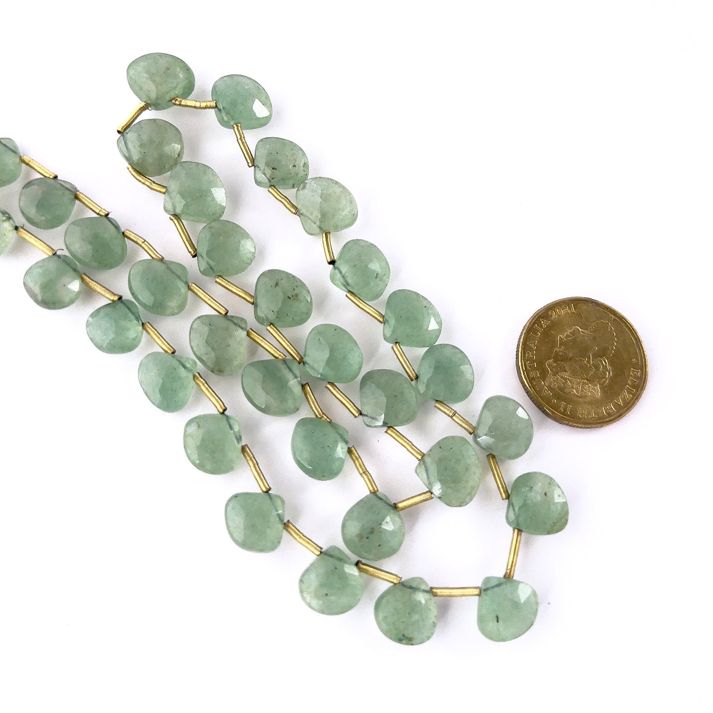 A coin is placed near Strawberry Quartz briolette beads to show the 10.3–13mm size range.