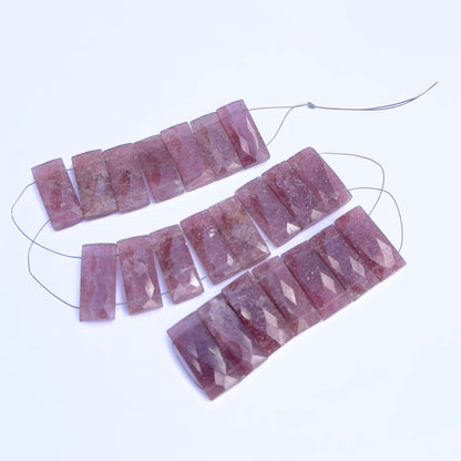 Close-up of Strawberry Quartz rectangle beads showing their clarity, cut, and natural inclusions.
