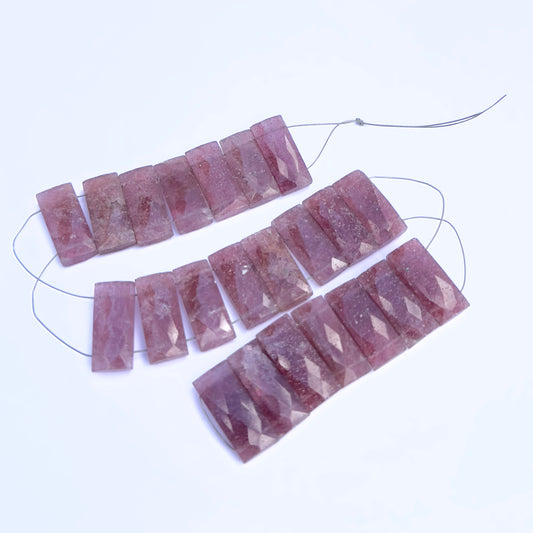Close-up of Strawberry Quartz rectangle beads showing their clarity, cut, and natural inclusions.