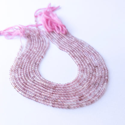 Close‑up of authentic Strawberry Quartz faceted rondelle stone beads highlighting sparkle, colour, and quality for DIY jewellery making.
