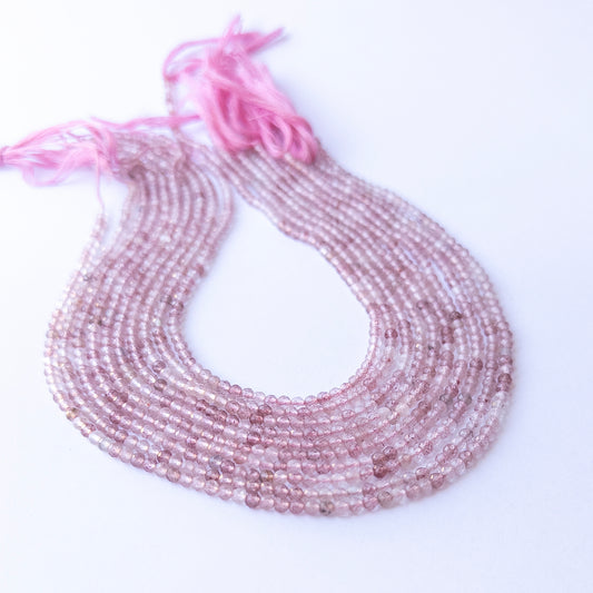 Close‑up of authentic Strawberry Quartz faceted rondelle stone beads highlighting sparkle, colour, and quality for DIY jewellery making.