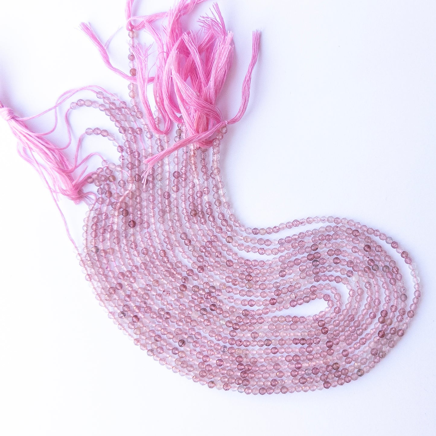 Strawberry Quartz faceted rondelle beads with natural variation, perfect for handmade jewellery components and creative beadwork.