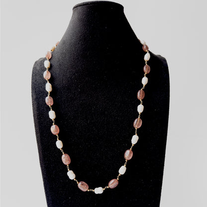 Genuine Strawberry Quartz gemstone necklace showcasing smooth oval beads and radiant Freshwater Pearl highlights.