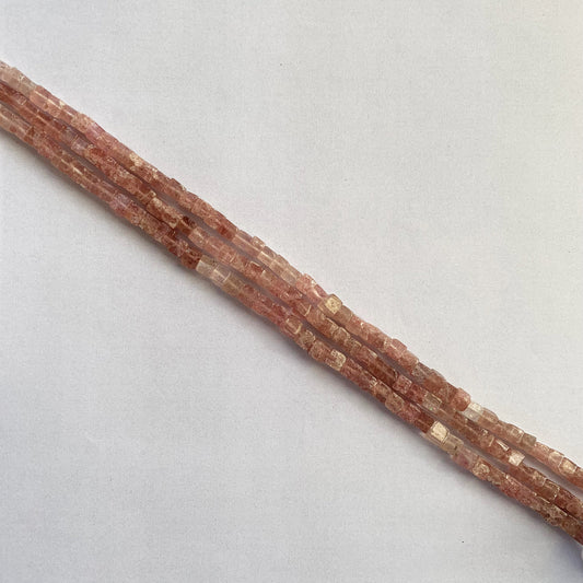 Smooth cube Strawberry Quartz beads in soft pink tones, aligned on a 21cm strand with natural shine and uniform shape.