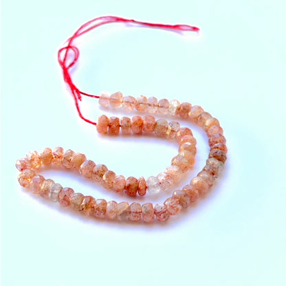 Close‑up of 5mm Sunstone stone beads showing glittery facets and soft shimmer ideal for natural gemstone beads for DIY jewellery.