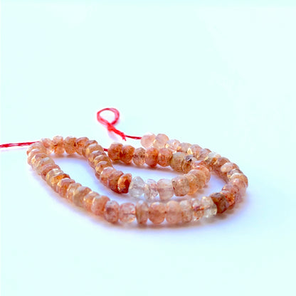 Sunstone faceted rondelle beads aligned on a strand highlighting clarity, shine and consistent 5mm sizing.