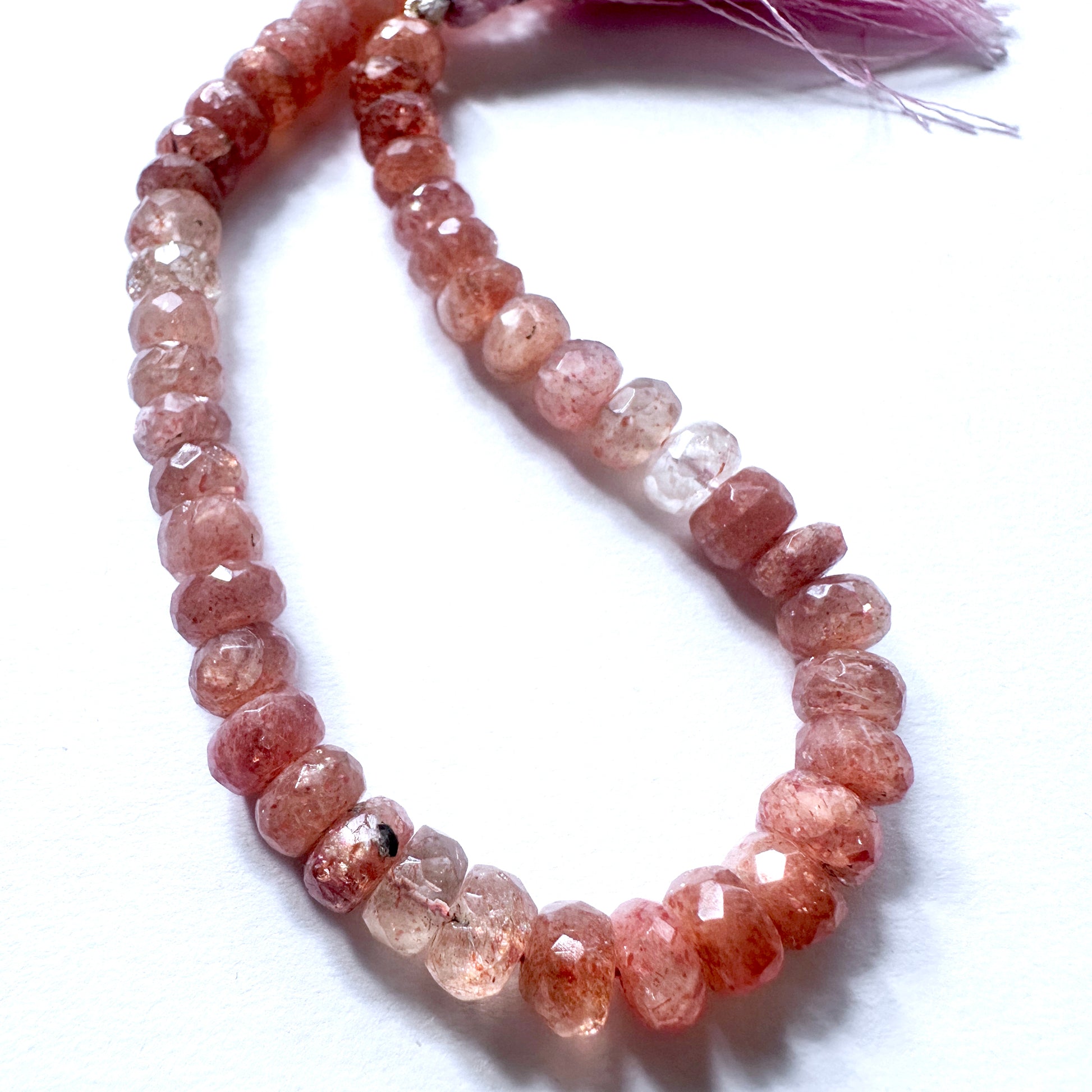 Stone Beads featuring Sunstone with consistent rondelle shape and shimmering surface.