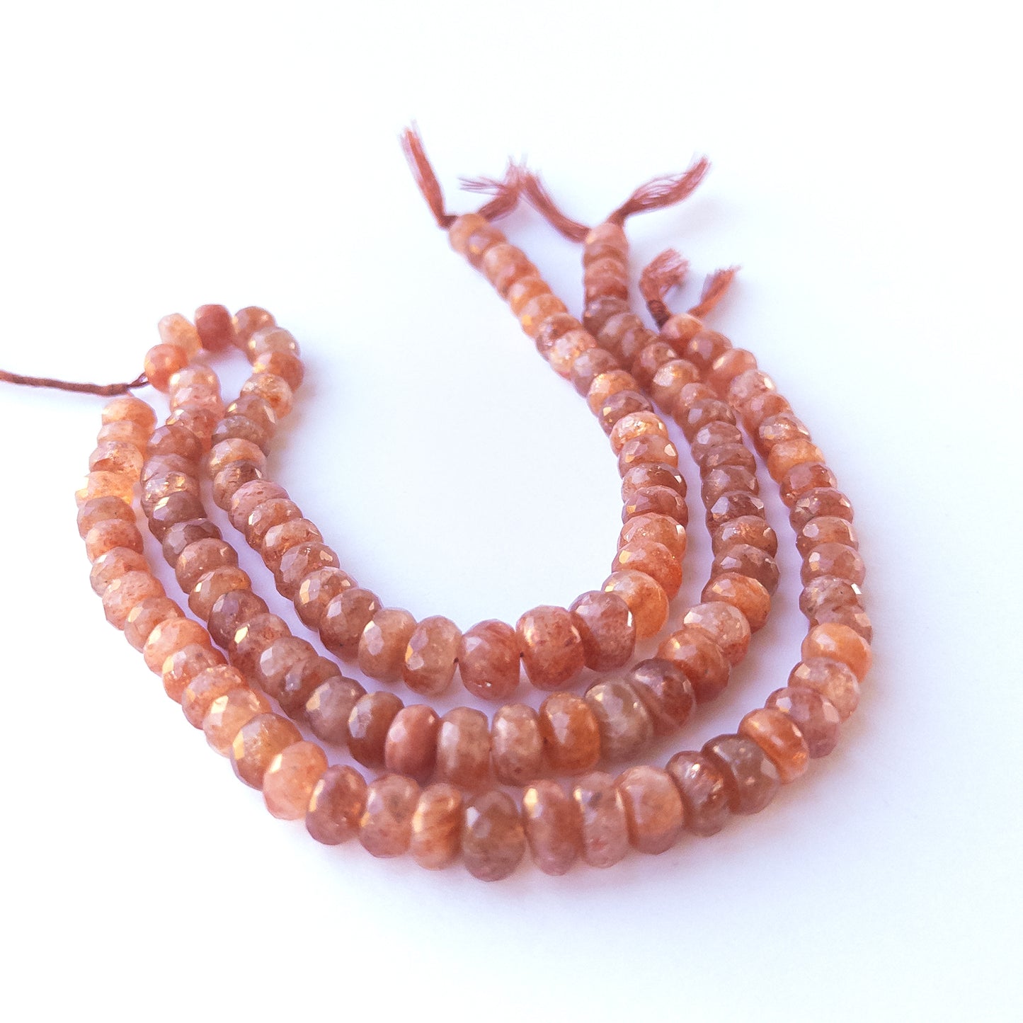 Close‑up of genuine Sunstone faceted rondelle beads highlighting their sparkle, clarity and textured faceting.