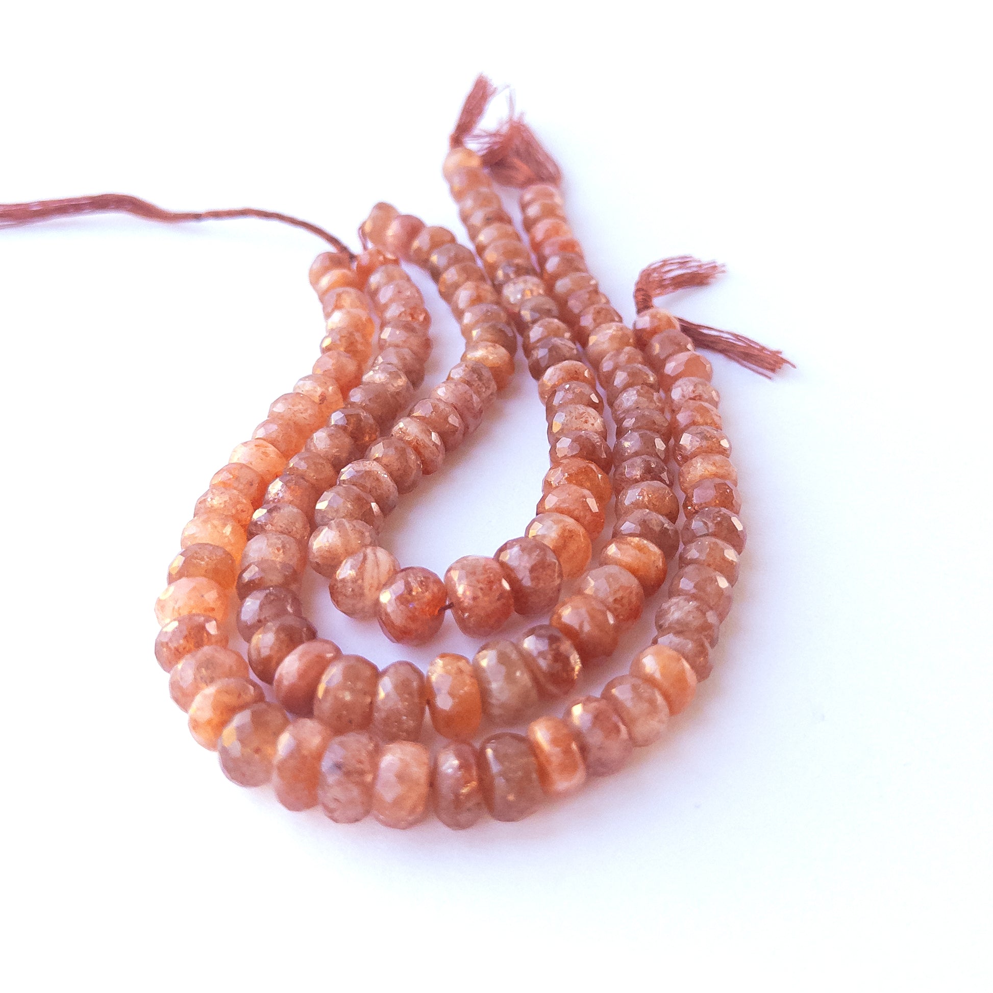 Natural Sunstone faceted rondelle beads showing warm peach tones and mixed 7–9.5mm sizes for DIY jewellery designs.