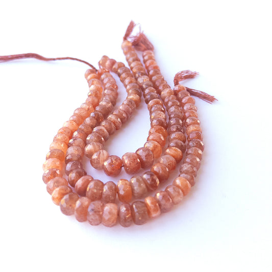 Natural Sunstone faceted rondelle beads showing warm peach tones and mixed 7–9.5mm sizes for DIY jewellery designs.